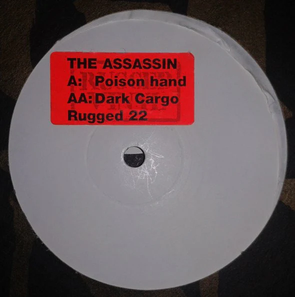 The Assassin – Poison Hand / Dark Cargo (VG/Generic) – 12", UK 1999